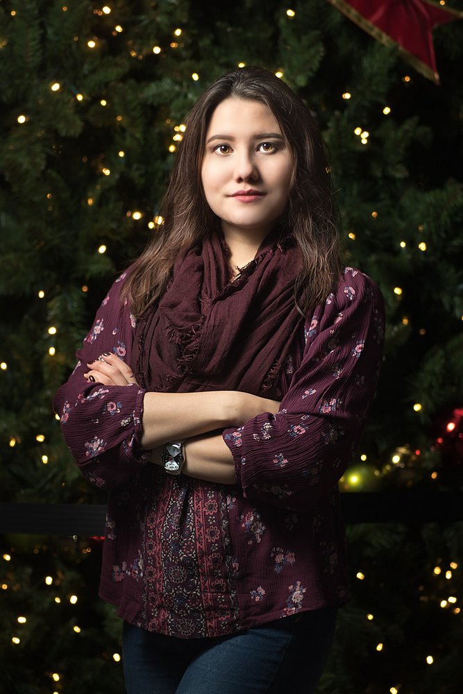 model behind a christmas tree photographer